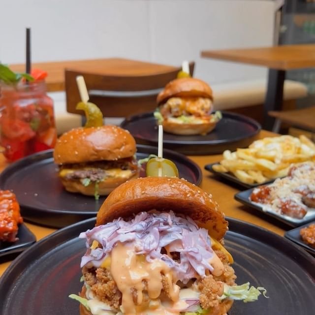 A close-up of a burger with crispy chips served at Band of Burgers Fulham.