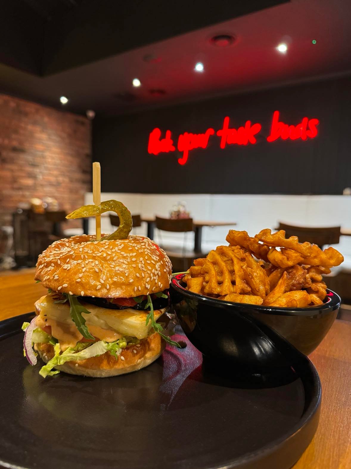 uicy loaded burger served with crispy potato waffles at Band of Burgers Fulham, London